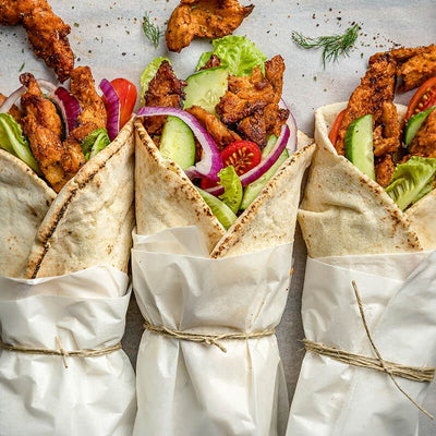 Chick*n fillets gyros in Lebanese pitta with vegan tzatziki